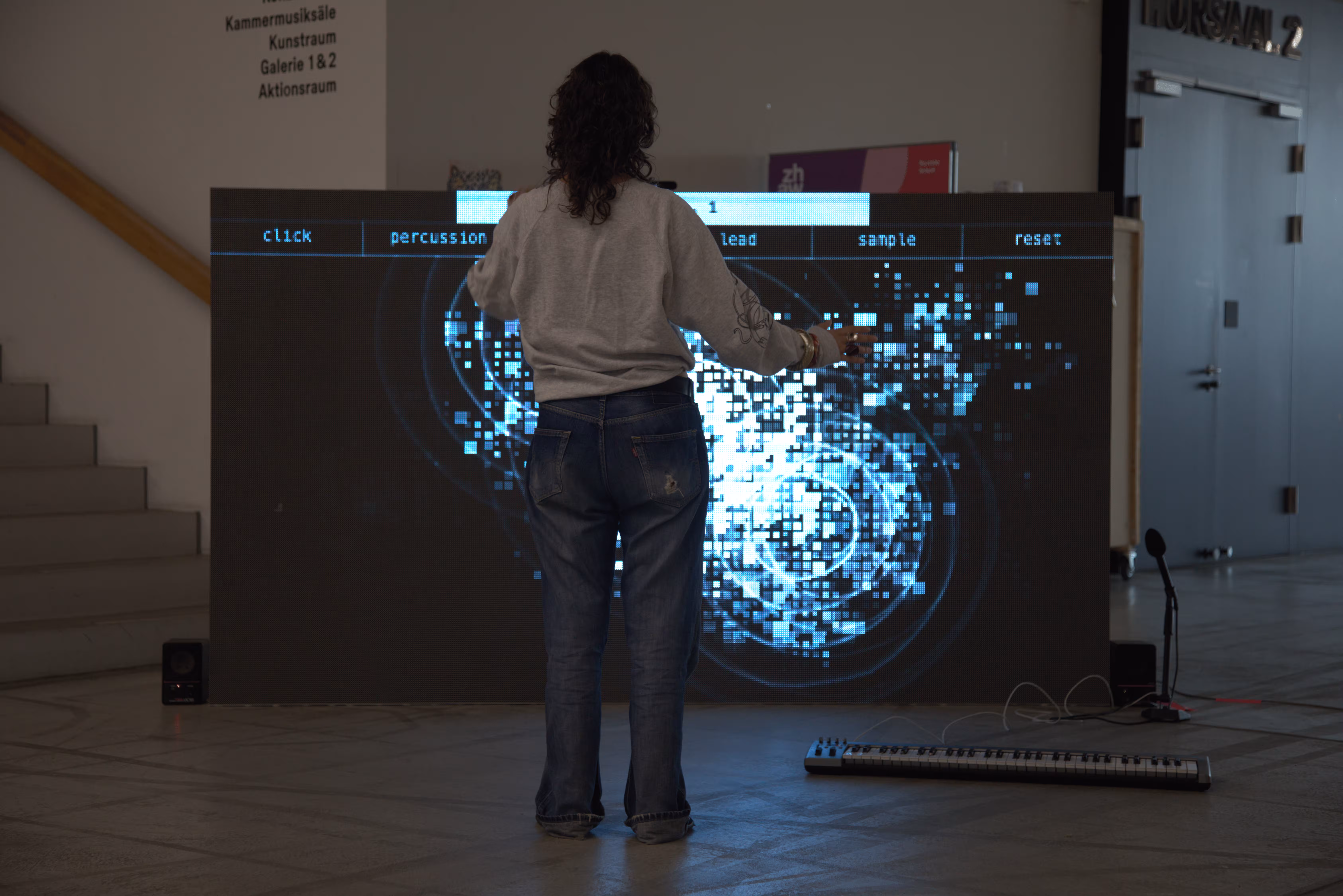 Person with open arms, blue pixel cloud on the screen